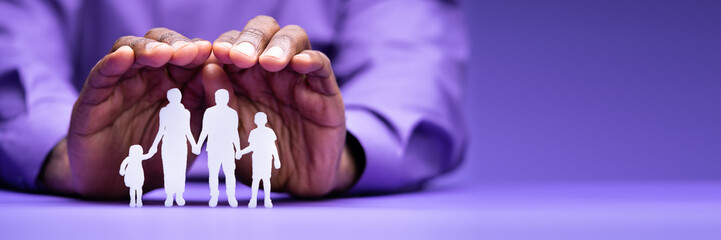 Businessperson's Hand Protecting Family Figure Cut