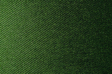 Dark green background of textile material with wicker pattern, close up. The structure of olive tissue. Fabric background