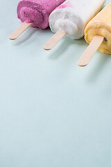 Some different colorful ice creams a blue background 