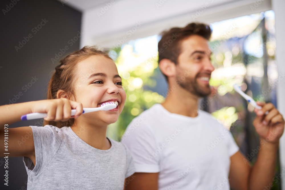 Sticker No Dad, brush like this. Cropped shot of a handsome Dad and his daughter brushing their teeth in the bathroom.