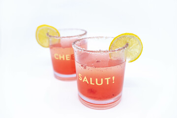 Summer Raspberry Lemon Cocktail Mix with lemon slices on glasses with Cheers and Salut