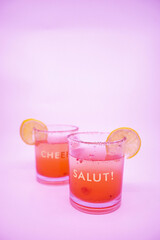 Summer Raspberry Lemon Cocktail Mix with lemon slices on glasses with Cheers and Salut