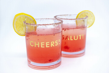 Summer Raspberry Lemon Cocktail Mix with lemon slices on glasses with Cheers and Salut