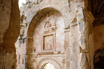 Ruins in rock of the structure of a church, with the detailed artistic engravings of the masonry...
