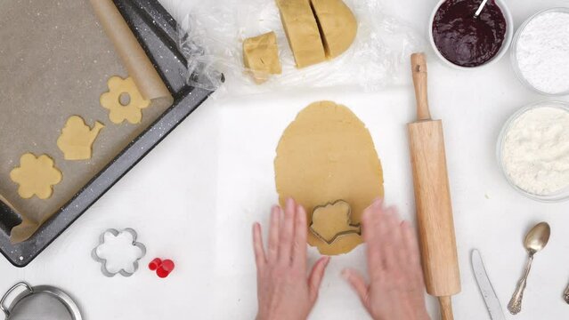 Flower shaped shortbread cookies filled with raspberry jam recipe. Step by step baking process