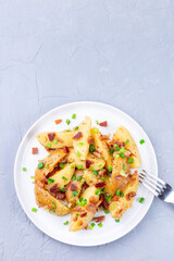 Bacon and onion potato salad with apple cider vinegar and mustard, on plate, vertical, copy space