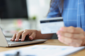Credit bank card in hand and computer keyboard