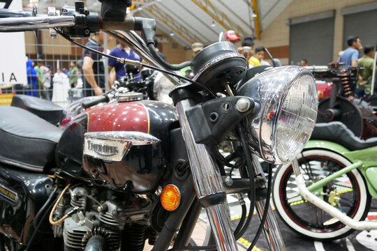 SELANGOR, MALAYSIA - 8 APRIL 2022: Branded motorcycle classic headlights installed on custom motorcycles. The motorcycle was displayed to the public in a large showroom.
