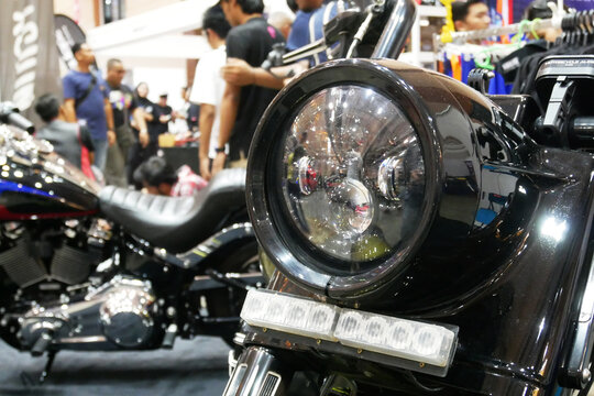 SELANGOR, MALAYSIA - 8 APRIL 2022: Branded motorcycle classic headlights installed on custom motorcycles. The motorcycle was displayed to the public in a large showroom.
