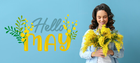 Beautiful young woman with bouquet of mimosa flowers and text HELLO, MAY on blue background
