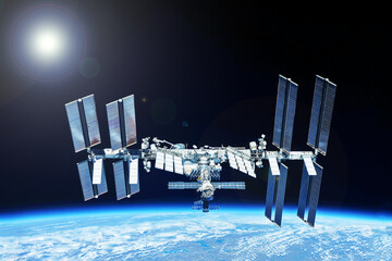 ISS over the planet, against the background of clouds. Elements of this image furnished by NASA