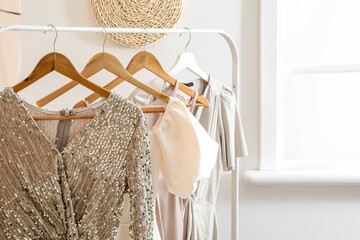 Rack with stylish clothes in modern studio of fashion stylist