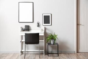 Modern workplace with stylish decor in interior of light room