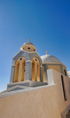 Greek church with blue dome near the sea in Oia town, Santorini island, Greece