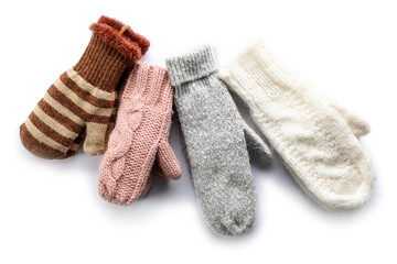 Different warm mittens on white background