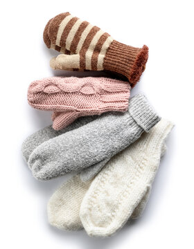 Different Warm Mittens On White Background