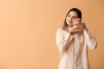 Beautiful young woman with cute guinea pig on color background