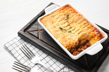 Baking dish with tasty Shepherd's pie on white wooden background