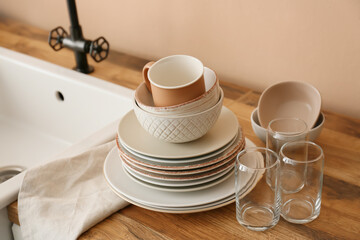 Set of clean tableware near sink in kitchen