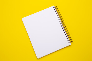 Blank notebook on a yellow background