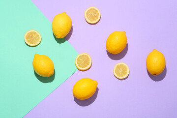 Ripe lemons and slices on color background, top view