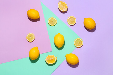 Ripe lemons and slices on color background, top view