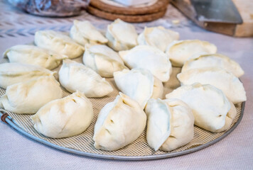 Fototapeta na wymiar Raw Chinese dumplings on the plate ready for steaming