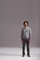 Ive got my sights set on the top. Studio shot of a handsome young man isolated on gray.