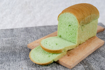 Green pandan bread loaf slice on a white background.	
