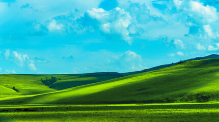 Hills, grasslands and blue sky