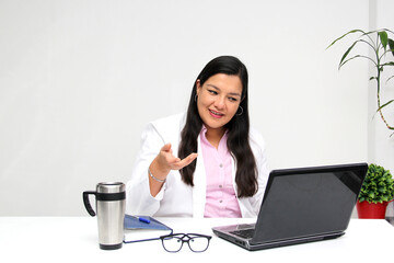 Latina medical doctor woman gives remote consultation by video call on the internet for the Covid-19 quarantine in the new normality due to the Coronavirus pandemic
