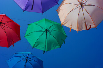 All colorful umbrella hanging and clear blue sky.