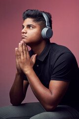 Music speaks to the soul. Studio shot of a handsome young man wearing headphones.
