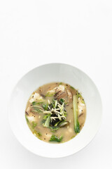 traditional japanese miso soup with tofu and vegetables on white background - 497826041