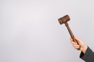 Woman holding judge's gavel on white background. 