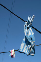 Drying socks on a clothes line at blue sky background.