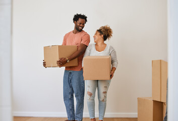 Home is where one starts from. Shot of a young couple moving in to their new home.
