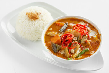 traditional thai chicken red curry with rice on white background
