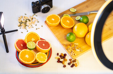 Mixed citrus, table ready to prepare photographic video content to share with social networks. Camera and lights