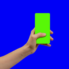 Female hand holding smartphone and thumb pressing button on green display, the device is located frontally flat lay
