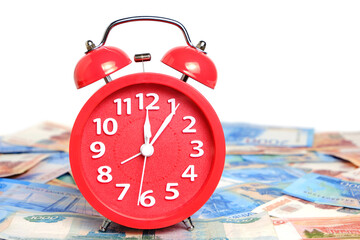 Russian rubles and red alarm clock white background.Time Russian ruble.