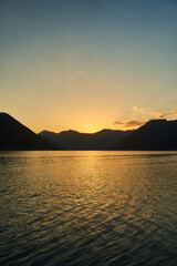 Fototapeta premium View of the sunset in Boko-Kotor Bay in Montenegro. Silhouettes of mountains