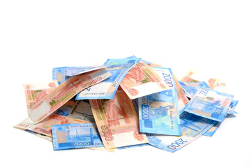 Bunch of Russian rubles in denominations of two and five thousand on a white background.