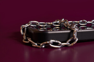 Nomophobia. The smartphone is rewound by a chain 