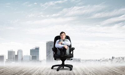 scared businessman on a chair
