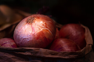 Red onion lit in a paper sack at a market in Mexico, selective focus.