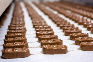 Production of chocolate bars. Confectionery factory. - obrazy, fototapety, plakaty