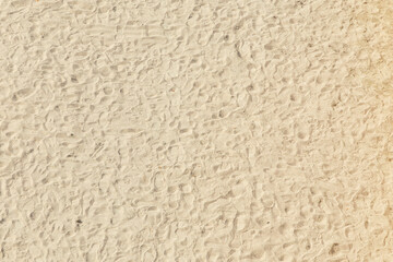 footprints at the sunny beach in Summer