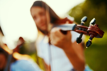 Music is life thats why our hearts have beats. Cropped shot of a young girl playing a violin outdoors.