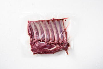 Racks of lamb meat rib fresh pack, on white stone table background, top view flat lay, with copy space for text